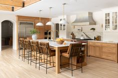 a large kitchen with wooden cabinets and an island