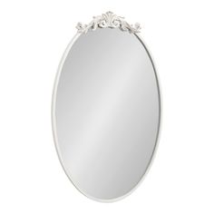 a white oval mirror with an ornate design on the top and bottom edge, against a white background