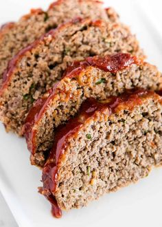 sliced meatloaf on a white plate with ketchup