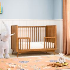 an elephant standing next to a baby crib