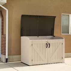 an open storage box on the side of a house