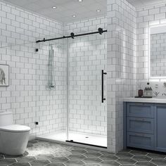 a white tiled bathroom with blue cabinets and gray floor tiles on the walls, along with a walk in shower