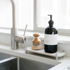 a soap dispenser sitting on top of a kitchen sink