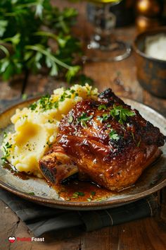 a plate with meat, mashed potatoes and garnishes on the side