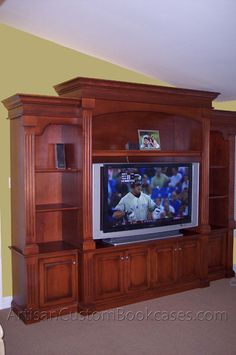 a large entertainment center in a living room with a flat screen tv on the wall