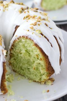 a bundt cake with white frosting and sprinkles on it sitting on a plate