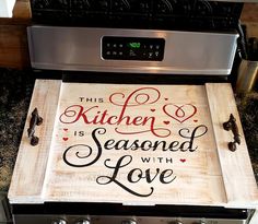 this kitchen is seasoned with love sign on an oven