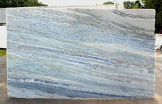 a large blue marble slab sitting on top of a parking lot