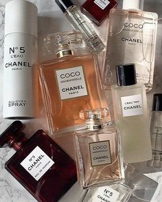 many different types of perfumes on a marble surface