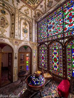 an ornate room with many colorful stained glass windows