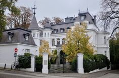 a large white house with many windows and towers