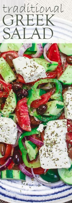 a salad with cucumbers, tomatoes, olives and feta cheese