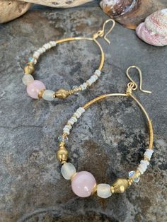 Beautiful gemstone beaded hoop earrings .. crafted with hand forged gold tone hoops .. Java glass beads .. Czech beads .. African recycled glass beads .. African brass beads and pretty Rose Quartz focal beads . These unique boho hoops measure 3 inches in length and have hand wire wrap detail . Gold Beaded Earrings With Natural Stones, Gold Earrings With Gemstone Beads, Wire Wrapped Round Beaded Earrings With Czech Glass, Wire Wrapped Czech Glass Beaded Earrings, Wrapped Hoop Earrings, African Brass Beads, Boho Style Bracelets, Boho Hoop Earrings