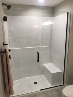 a bathroom with a walk in shower next to a toilet