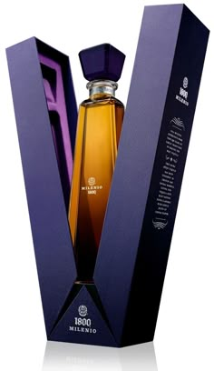 a bottle of perfume sitting inside of a purple box on top of a white surface