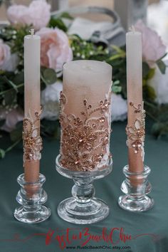 three candles are sitting next to each other on a table