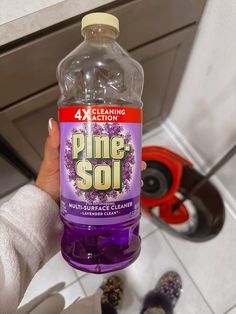 someone holding up a bottle of pine soi