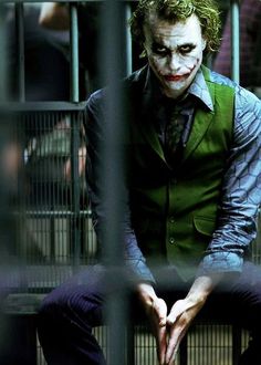 the joker is sitting in his jail cell