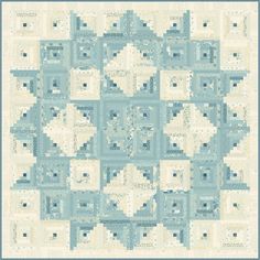 a blue and white quilt with an intricate design on the front, in shades of light blue