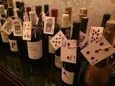 several wine bottles with cards attached to them