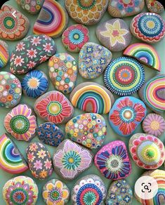 many colorful rocks are arranged together on the table and one is painted with different colors