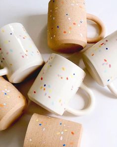 several coffee cups with sprinkles on them