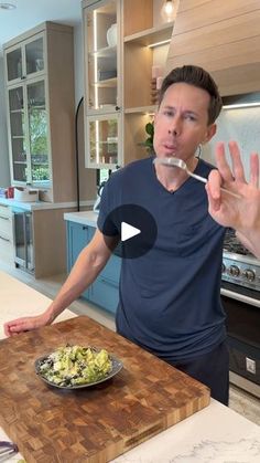 a man standing in front of a cutting board with food on it