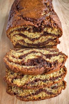 a loaf of chocolate swirl bread sitting on top of a wooden cutting board