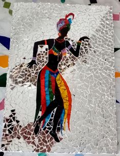 a piece of art that looks like a woman with a colorful dress and headdress