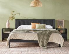 a bedroom with green walls and a bed in the middle is decorated with decorative items