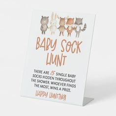 a sign that says baby sock lunt on the front and back of it's frame