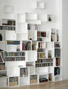 a white book shelf filled with lots of books