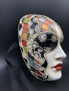 "Size: one size Traditional and original papier-mache Venetian mask, handmade and decorated with trimmings, stucco and acrylics. This traditional Venetian mask shape is called \"Volto mask\" and is a full face mask. This mask remembers Harlequin for the style of the decoration and its coloros. All our masks are handmade papier-machè masks, made in Venice. Our decorators use techniques typical of the Venetian tradition such as stucco, acrylics, gold and silver-leaf, macramè, passementerie, pearls Abstract Mask Design, Multicolor Masks And Prosthetics For Masquerade And Carnival, Multicolor Masks And Prosthetics For Carnival Masquerade, Venetian Multicolor Masquerade Mask, Artistic Multicolor Masquerade Mask For Carnival, Multicolor Masks For Masquerade Carnival, Multicolor Carnival Eye Mask, Multicolor Costume Mask, Artistic Multicolor Masquerade Mask For Mardi Gras