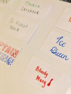 many different types of stickers on a white surface with the words written in red, blue and green