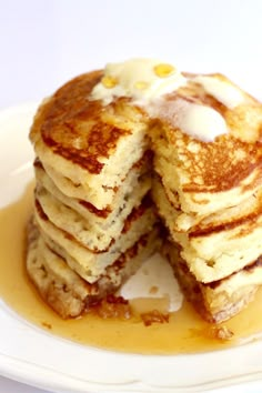 a stack of pancakes with butter on top and syrup drizzled over them