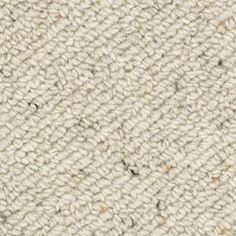 the texture of an upholstered carpet is shown in white and beige colors with brown spots