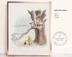 a winnie the pooh poster hanging on a wall next to a wooden frame with an image of a tree