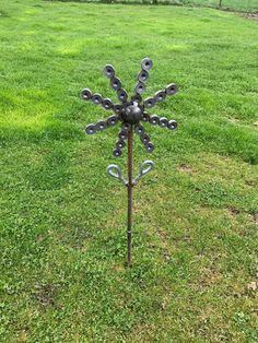 a metal snowflake in the middle of a grassy field