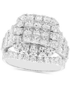 a white gold ring with two rows of square cut diamonds on the sides and one row of baguetts in the middle