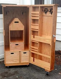 an open wooden cabinet sitting on top of a sidewalk