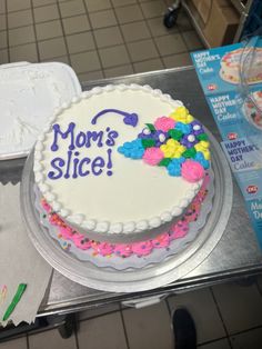 there is a cake that says mom's slice on the table next to it