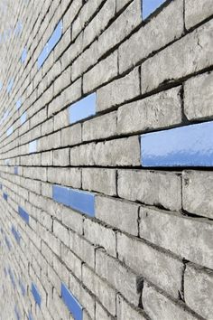 a brick wall with blue and white lines on the side, as seen from below