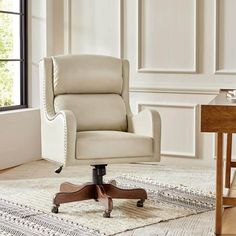 a white office chair sitting on top of a rug in front of a wooden table