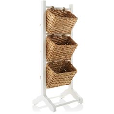 three wicker baskets on a white stand