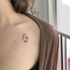 a woman with a small tattoo on her shoulder