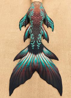 an image of a fish that is on the ground with it's tail spread out