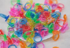 many different colored plastic rings on a white plate