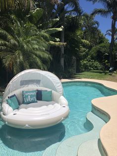 an inflatable chair sitting on top of a swimming pool