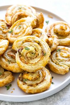 a white plate topped with pastry rolls on top of a table