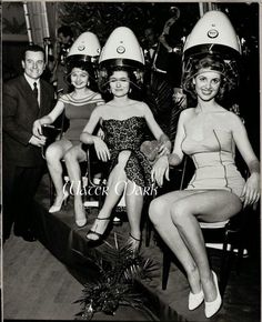 vintage black and white photograph of four women in bathing suits with helmets on their heads